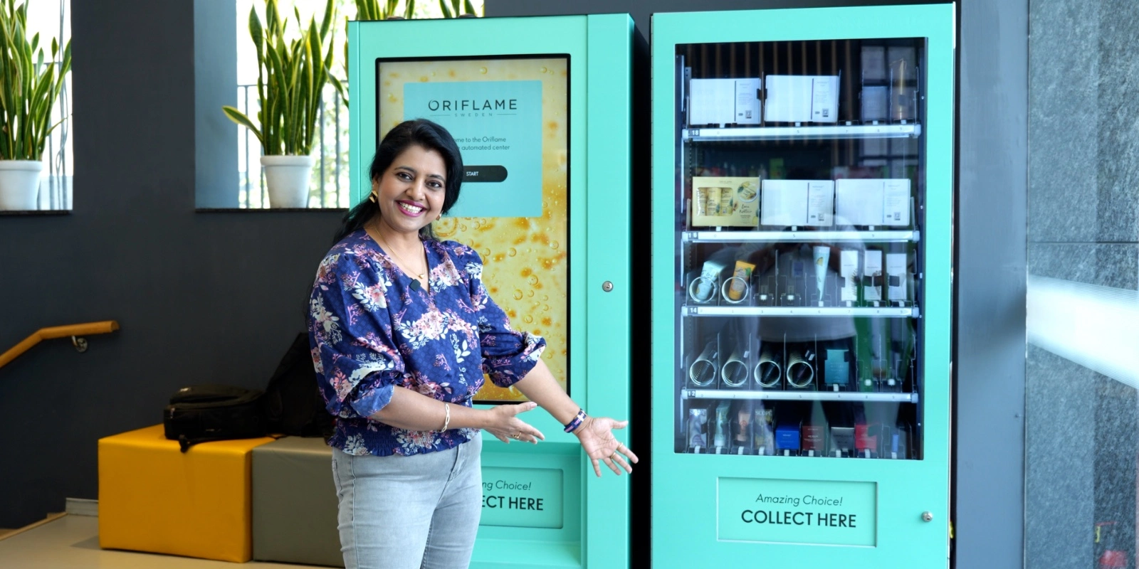 A smart vending machine displaying Oriflame products at an event booth.