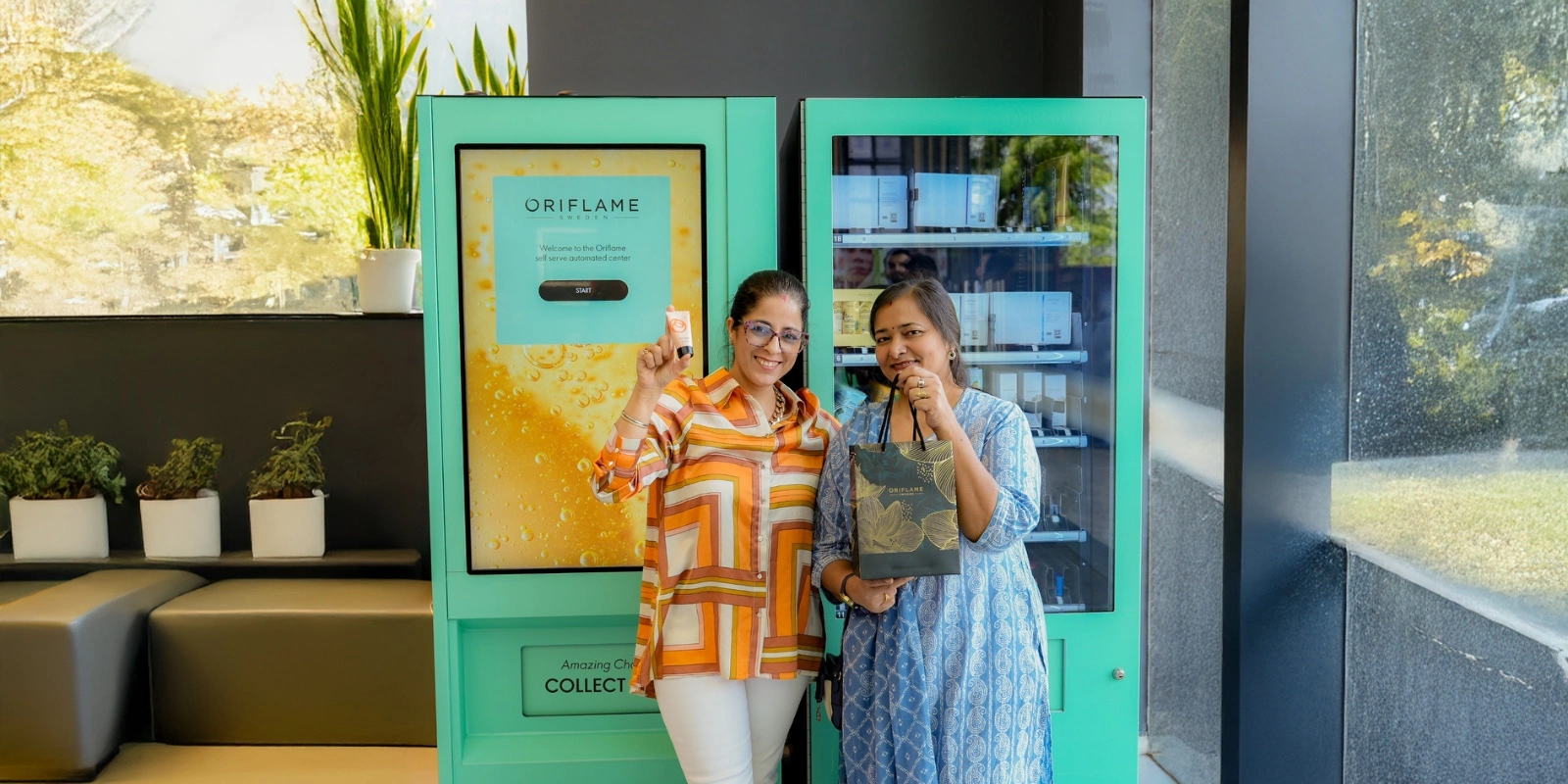 Oriflame branded smart vending machine placed next to a traditional product display counter, showing the integration of digital and physical retail.